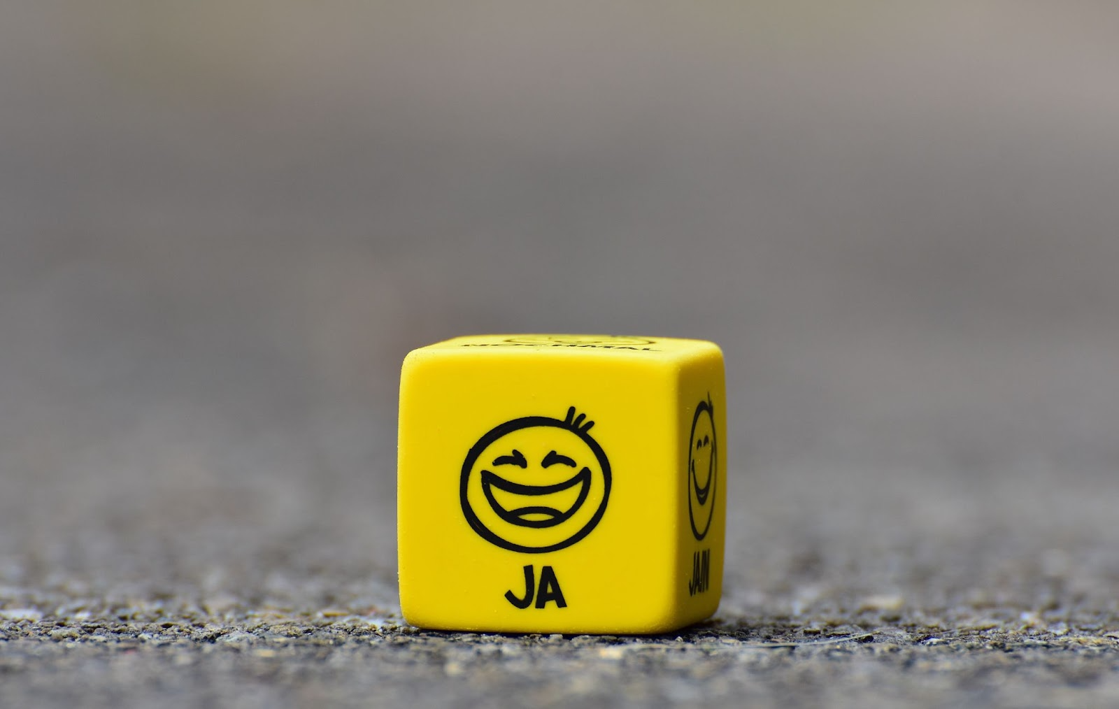 Source: https://www.pexels.com/photo/yellow-cube-on-brown-pavement-208147/